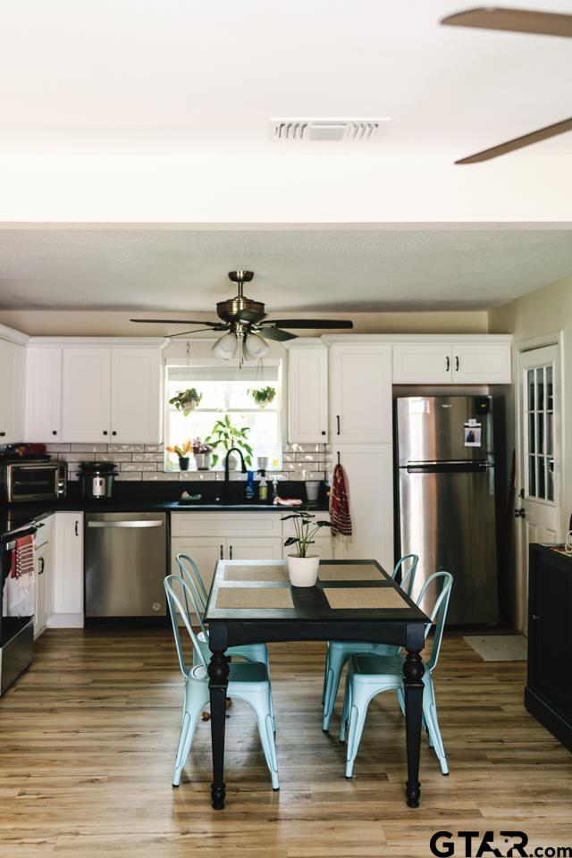 2411 Rodge Drive Tyler, TX 75701 - Photo 10 of 42 a kitchen with a table and chairs in it