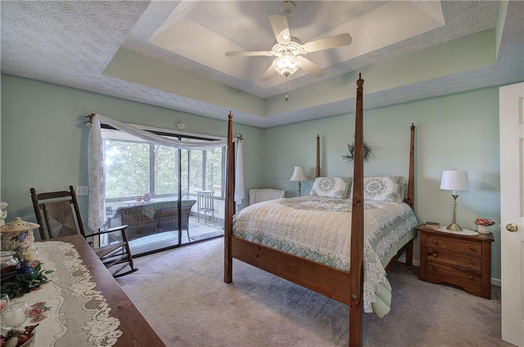 1379 Little Hendricks Mountain Road Jasper, GA 30143 - Photo 18 of 56 a bedroom with a bed a lamp and a large window