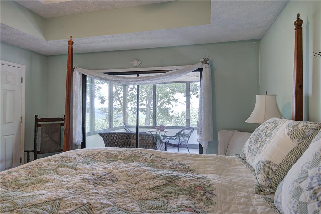 1379 Little Hendricks Mountain Road Jasper, GA 30143 - Photo 19 of 56 a bedroom with a large bed and a large window