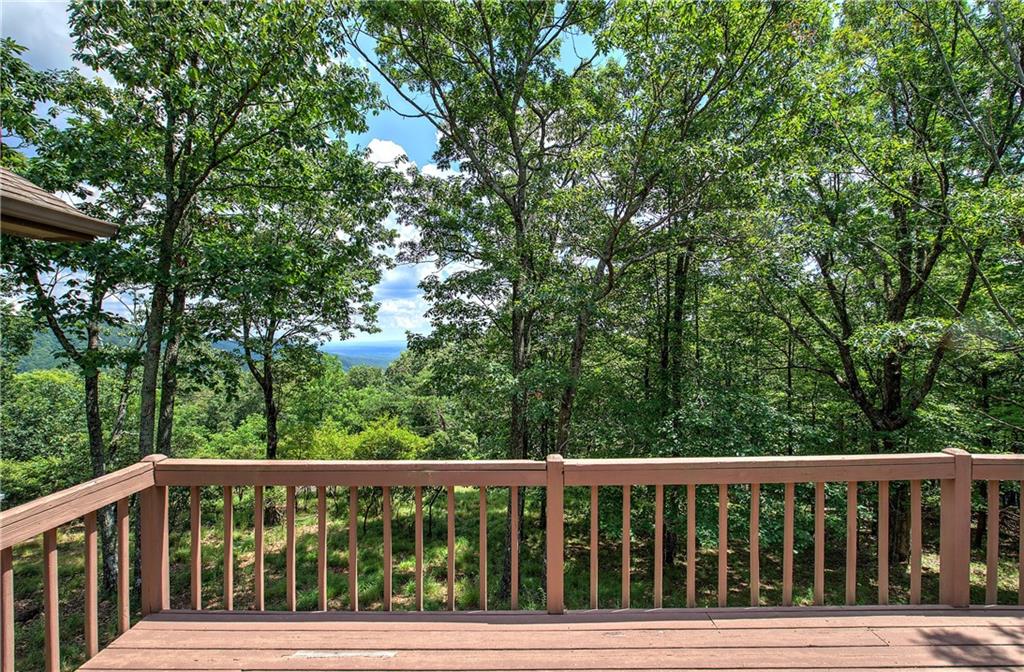 1379 Little Hendricks Mountain Road Jasper, GA 30143 - Photo 2 of 56 a balcony with wooden floor and fence