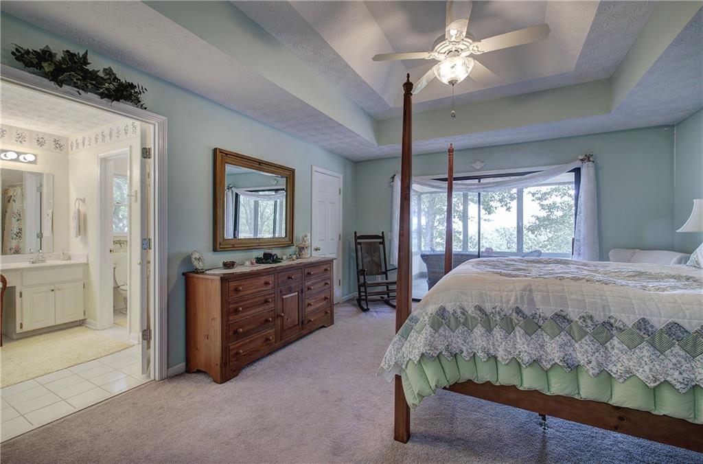 1379 Little Hendricks Mountain Road Jasper, GA 30143 - Photo 21 of 56 a bedroom with a bed and a chandelier