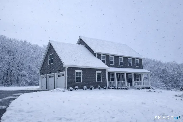 a front view of a house with a yard table and chairs