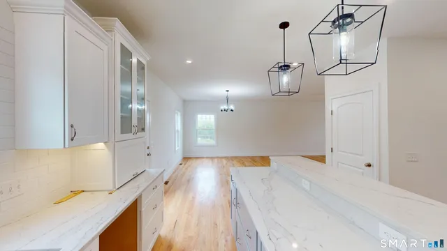 a view of a room with wooden floor and windows