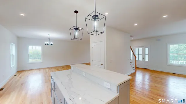 a view of a room with wooden floor and windows