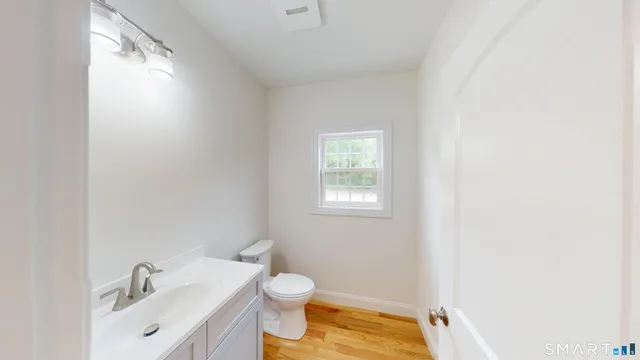 a bathroom with a sink toilet and vanity