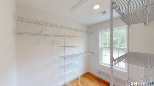 a view of walk in closet with empty racks