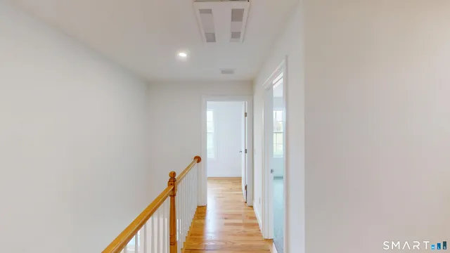 a view of a hallway with the wooden floor