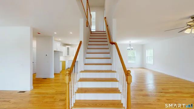 a view of entryway and hall with wooden floor