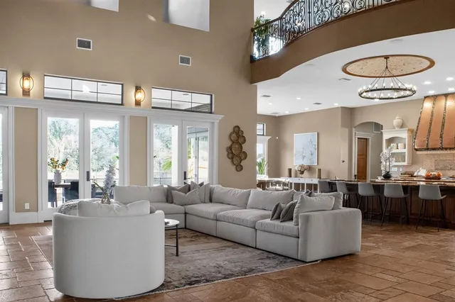a living room with furniture a mirror and a fireplace