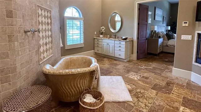 a living room with furniture fireplace and a large window