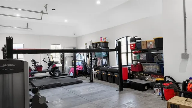 a front view of a house with a garden and trees