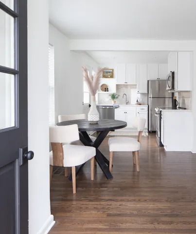 a dining room with furniture and wooden floor