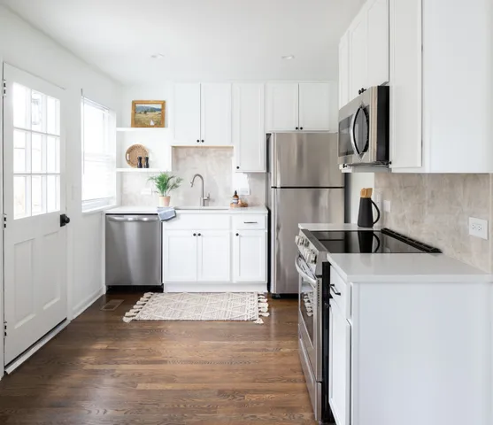 a kitchen with a sink a stove and refrigerator