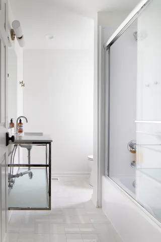 a bathroom with a shower and a sink