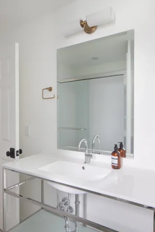 a bathroom with a sink and a mirror