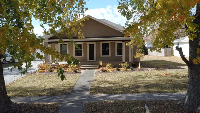 a view of a house with backyard porch and sitting area