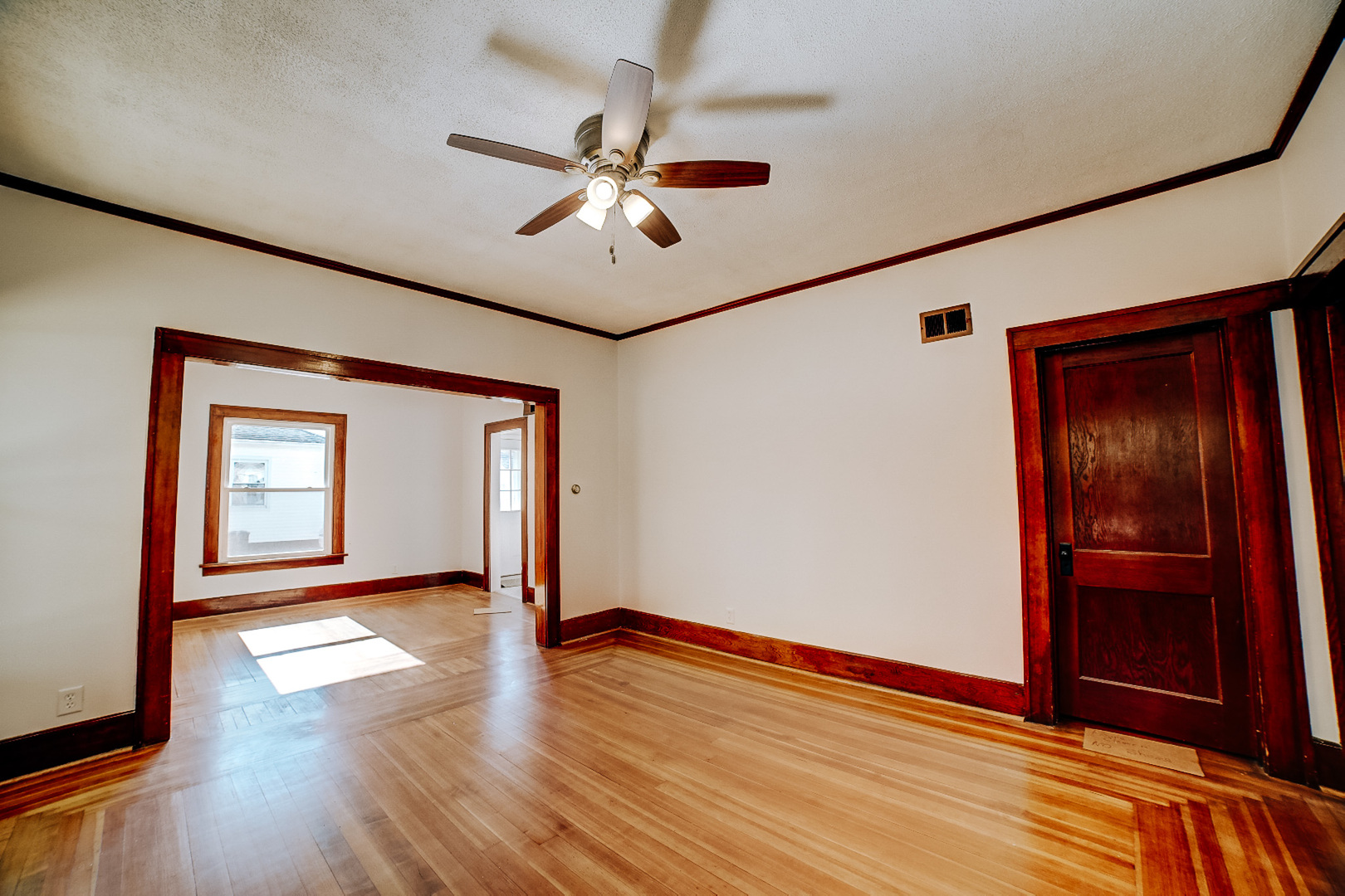 618 South Thomas Street Gilman, IL 60938 - Photo 11 of 38 a view of an empty room with wooden floor and a window