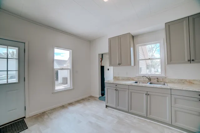 a kitchen with a sink cabinets and window