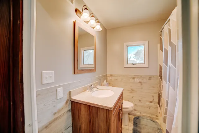 a bathroom with a sink a mirror and a shower
