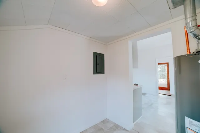 a view of a livingroom with an empty space and a refrigerator