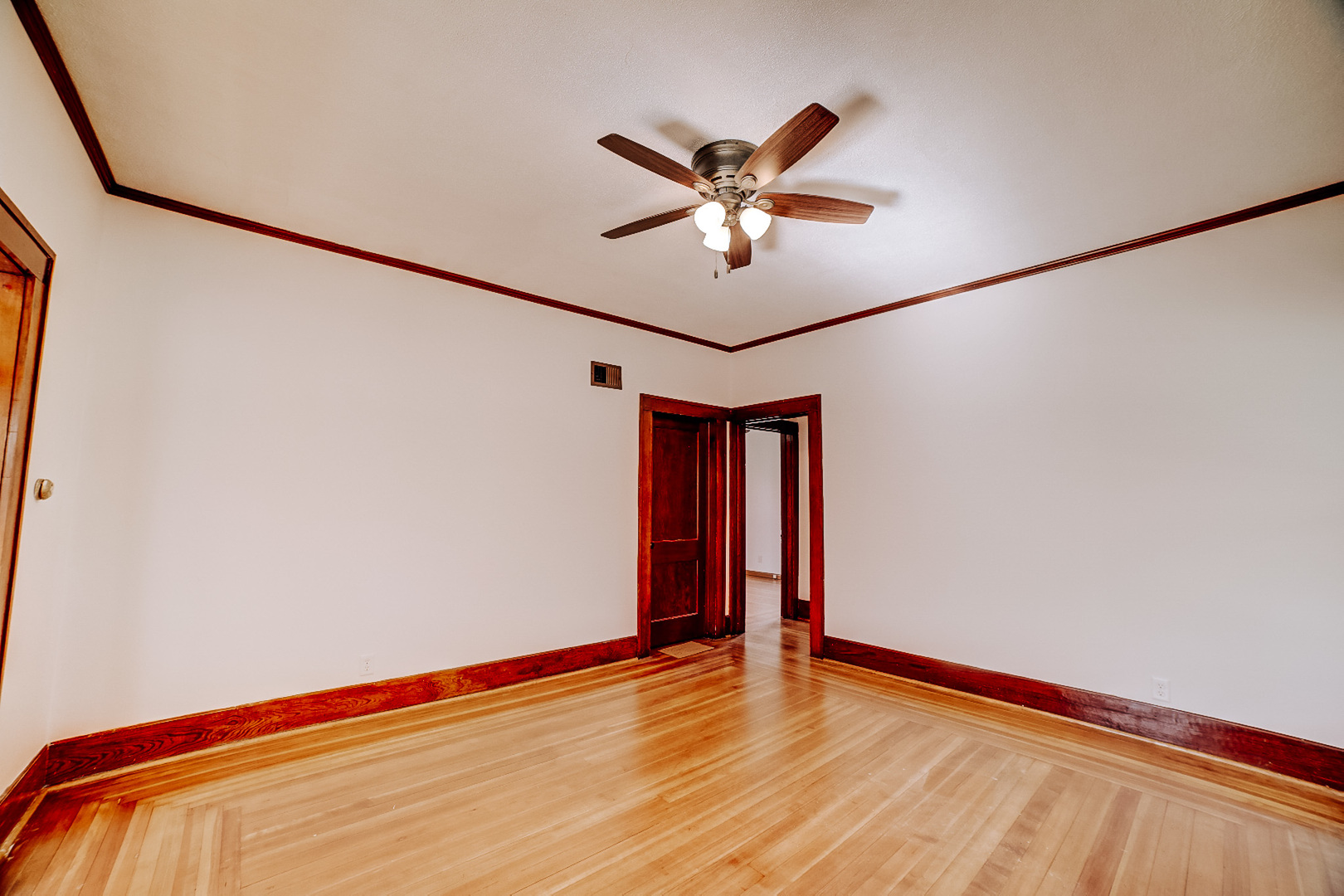 618 South Thomas Street Gilman, IL 60938 - Photo 10 of 38 a view of a room with wooden floor and fan