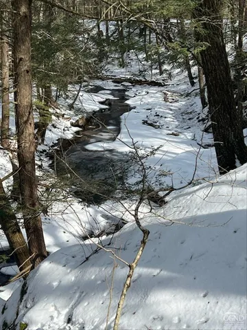 a view of snow in between the field