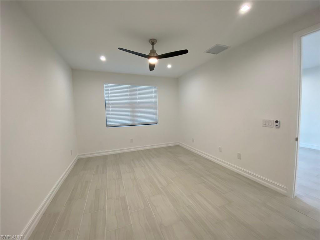 7530 Rockefeller Drive Naples, FL 34119 - Photo 11 of 18 Room featuring light-toned tile flooring, a modern ceiling fan, recessed lighting, and a single window with blinds
