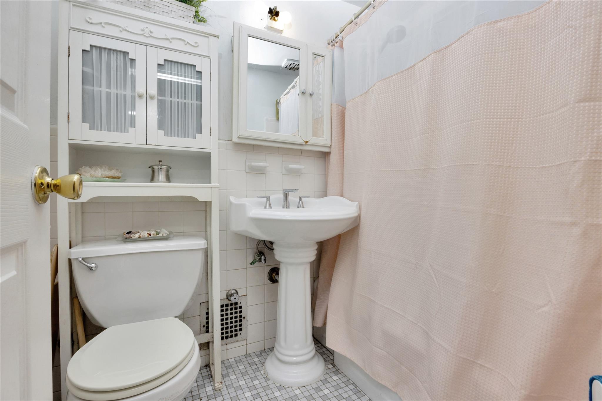 99-40 63rd Road, Unit 9Z Queens, NY 11374 - Photo 15 of 21 Full bath featuring tile patterned floors, tile walls, toilet, and a shower with curtain