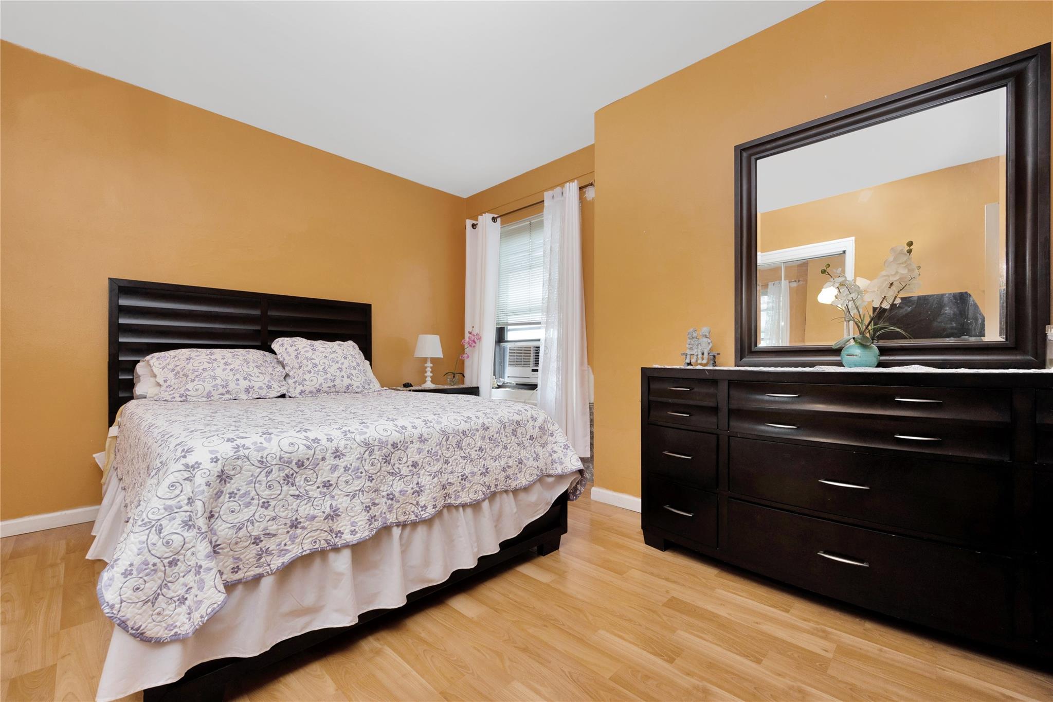 99-40 63rd Road, Unit 9Z Queens, NY 11374 - Photo 16 of 21 Bedroom with light wood finished floors, baseboards, and lofted ceiling