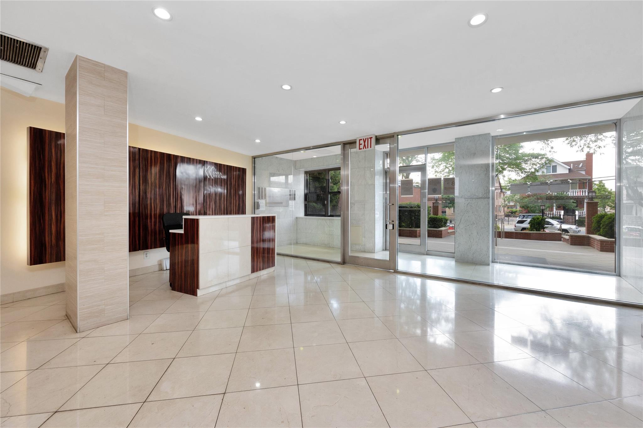 99-40 63rd Road, Unit 9Z Queens, NY 11374 - Photo 20 of 21 Kitchen with modern cabinets, light tile patterned flooring, recessed lighting, and a kitchen island
