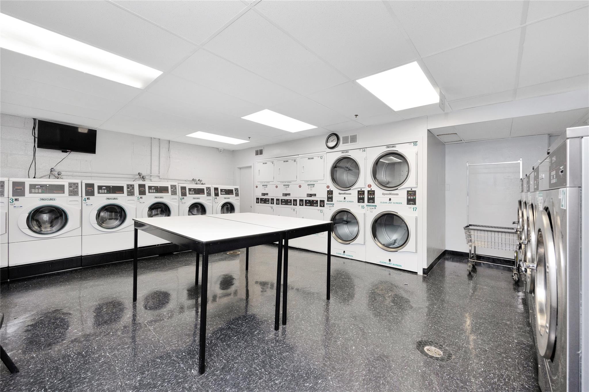 99-40 63rd Road, Unit 9Z Queens, NY 11374 - Photo 21 of 21 Shared laundry room with estacked washer and dryer, washer and dryer, and baseboards