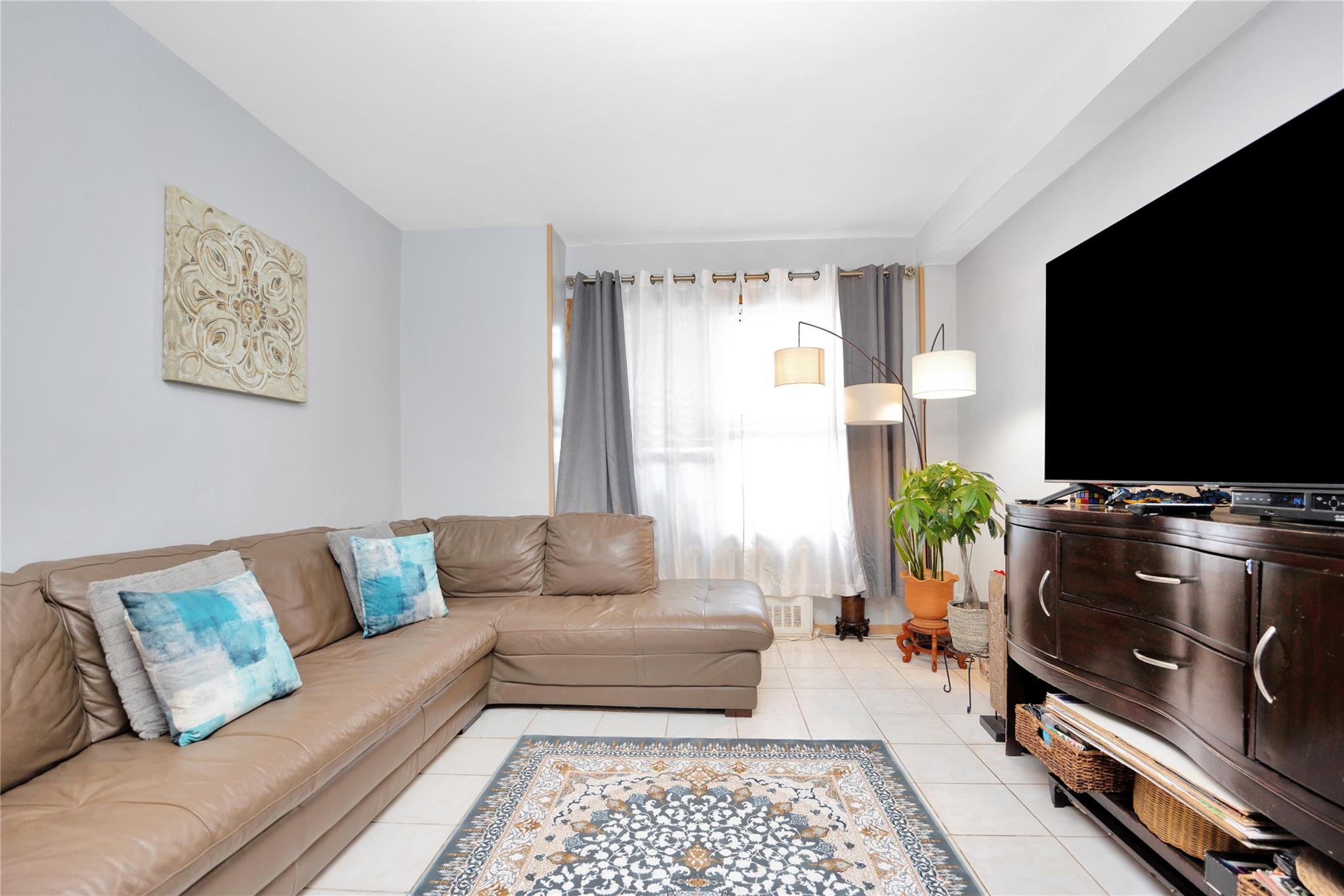 99-40 63rd Road, Unit 9Z Queens, NY 11374 - Photo 5 of 21 Living area with light tile patterned flooring