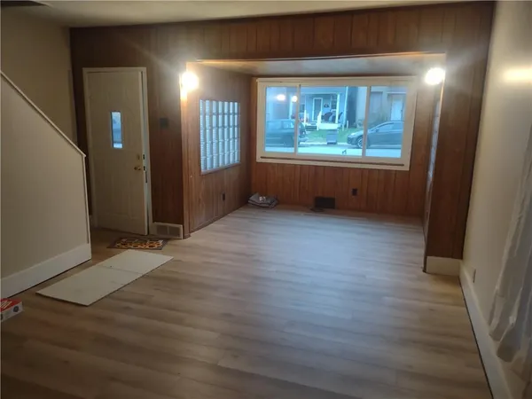 wooden floor in an empty room with a window