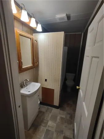 a bathroom with a sink a mirror and a shower