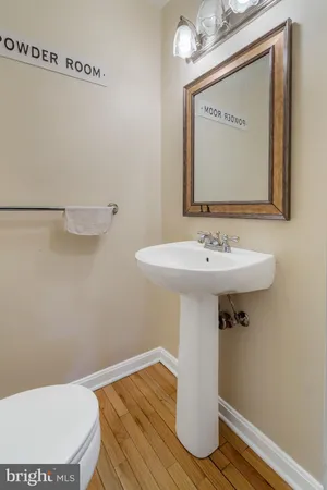 a bathroom with a sink a mirror and toilet