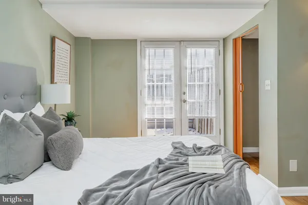 a bedroom with a large bed and a large window