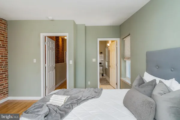 a bedroom with a bed and a mirror