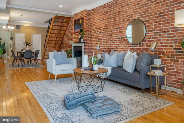 a living room with furniture a rug and a mirror