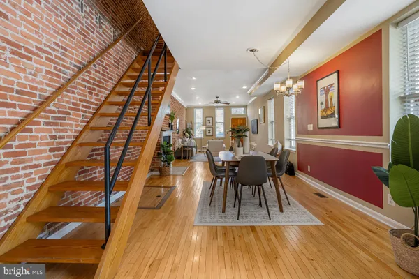 a dining room with furniture and wooden floor