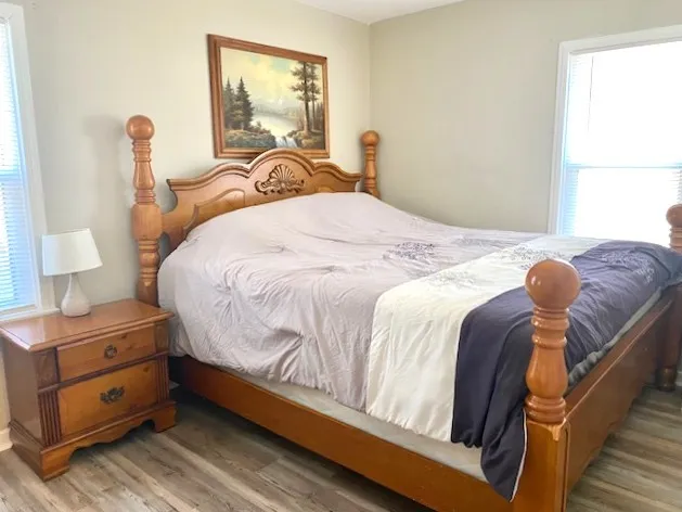 a bedroom with a bed and a window