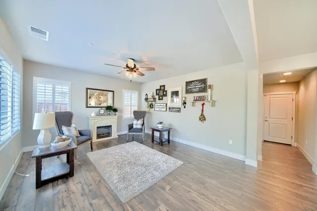 a dining room with furniture a chandelier and wooden floor