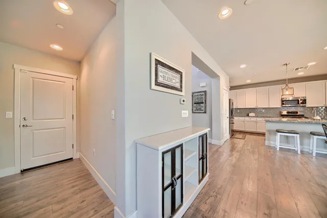 a large kitchen with stainless steel appliances granite countertop a stove oven and a sink