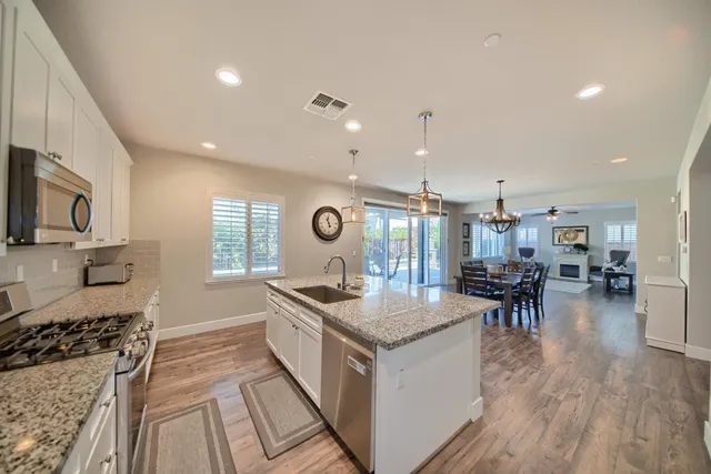a view of a hallway with wooden floor and furniture
