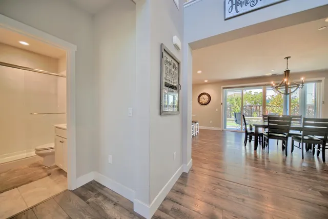a bedroom with a large bed and a chandelier