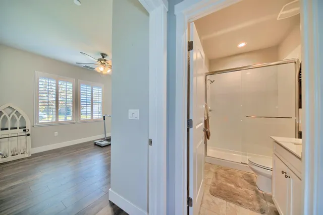 a spacious bathroom with a granite countertop sink a mirror and a bathtub