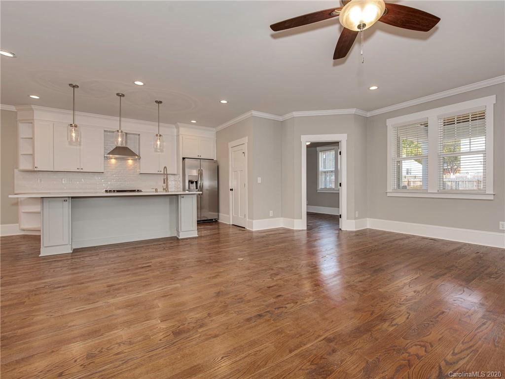 1808 Berryhill Road Charlotte, NC 28208 - Photo 12 of 34 a view of a kitchen with a stove cabinets and wooden floor