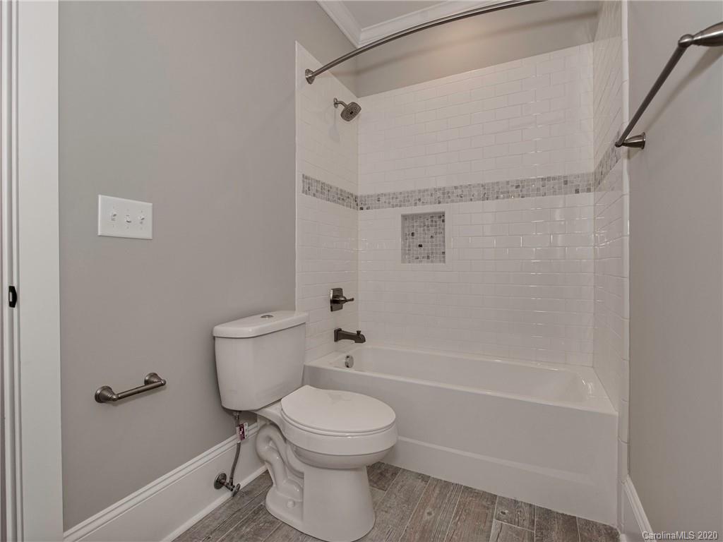 1808 Berryhill Road Charlotte, NC 28208 - Photo 19 of 34 a bathroom with a toilet and shower