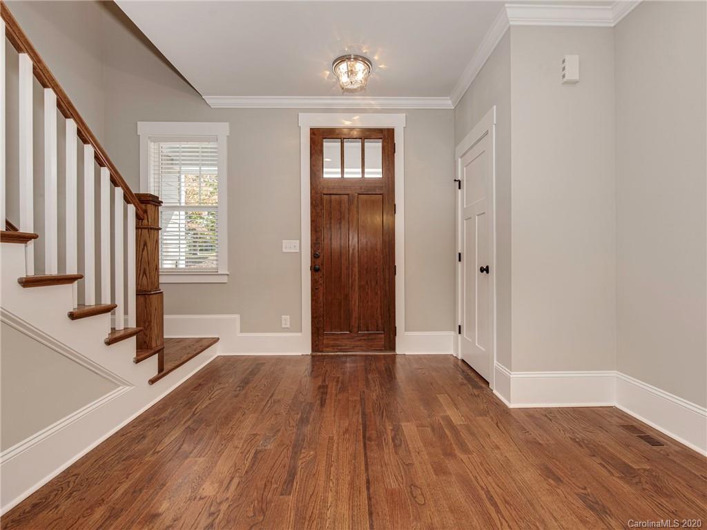 1808 Berryhill Road Charlotte, NC 28208 - Photo 3 of 34 a view of a room with wooden floor and stairs