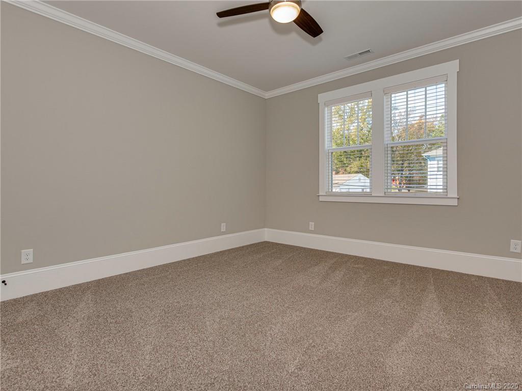 1808 Berryhill Road Charlotte, NC 28208 - Photo 21 of 34 an empty room with a window and a ceiling fan