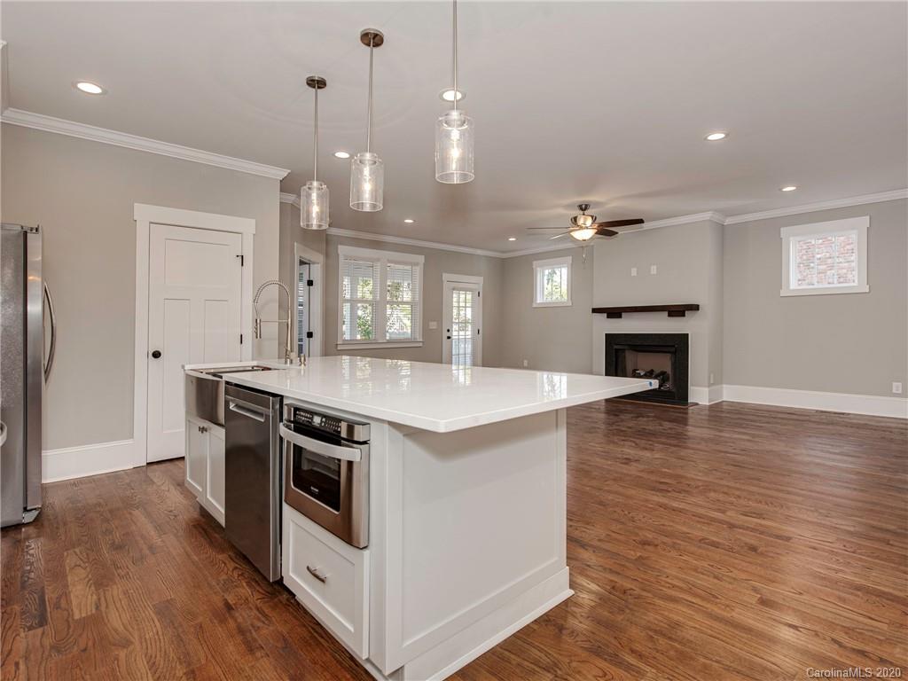 1808 Berryhill Road Charlotte, NC 28208 - Photo 7 of 34 a kitchen with stainless steel appliances granite countertop a sink a stove and a wooden floor